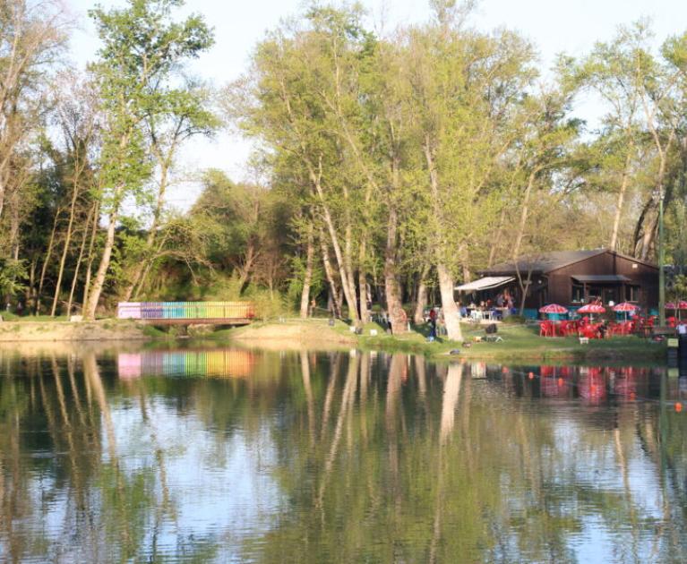 Peaceful lake, colorful reflections, serene nature, relaxing atmosphere with outdoor café.