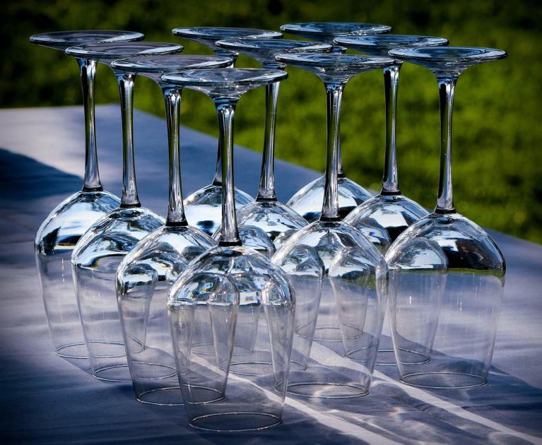 Upside-down glasses gleam in the sun, ready for an elegant toast.