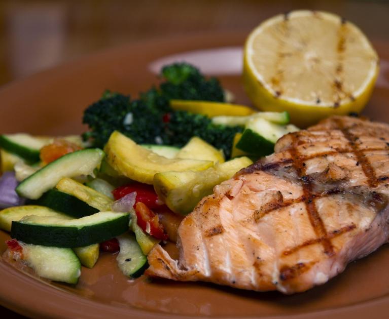 Grilled salmon with colorful vegetables, a burst of freshness and flavor.