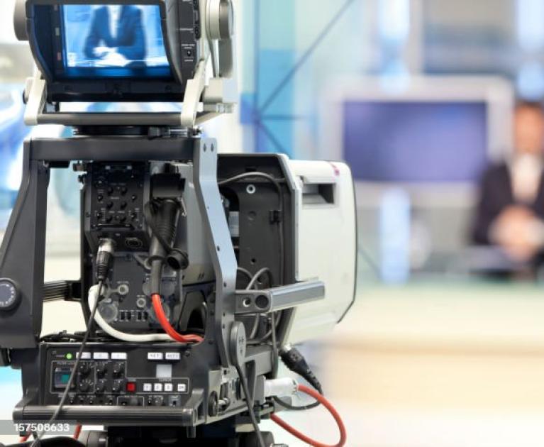 Camera in studio, atmosphere of anticipation and professionalism.