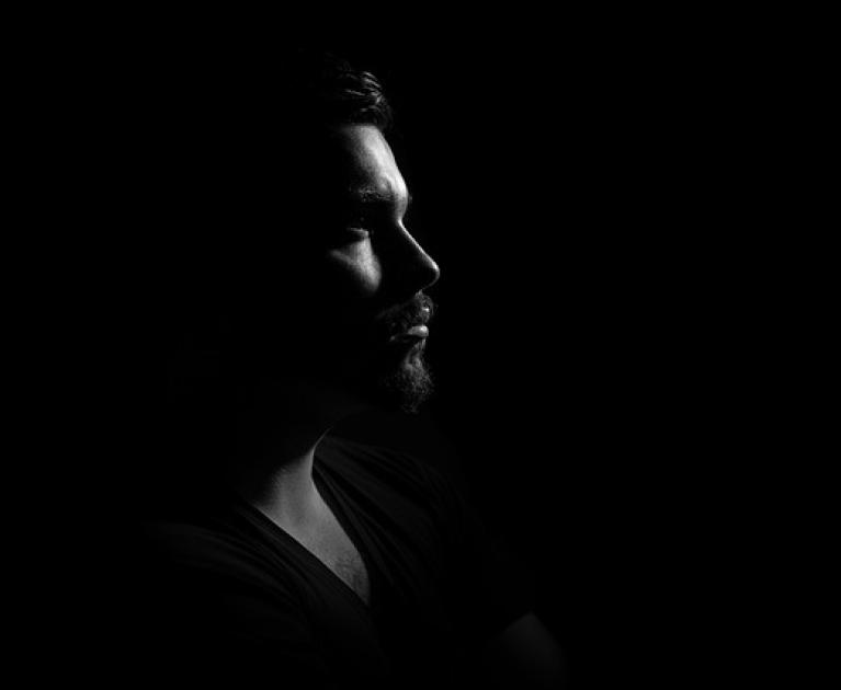 Male profile in shadow, evoking mystery and introspection.